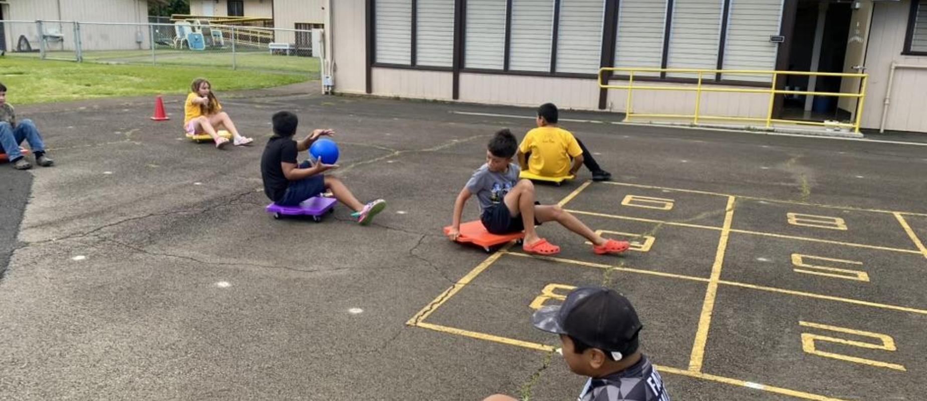 Students playing soccer on rollerboards