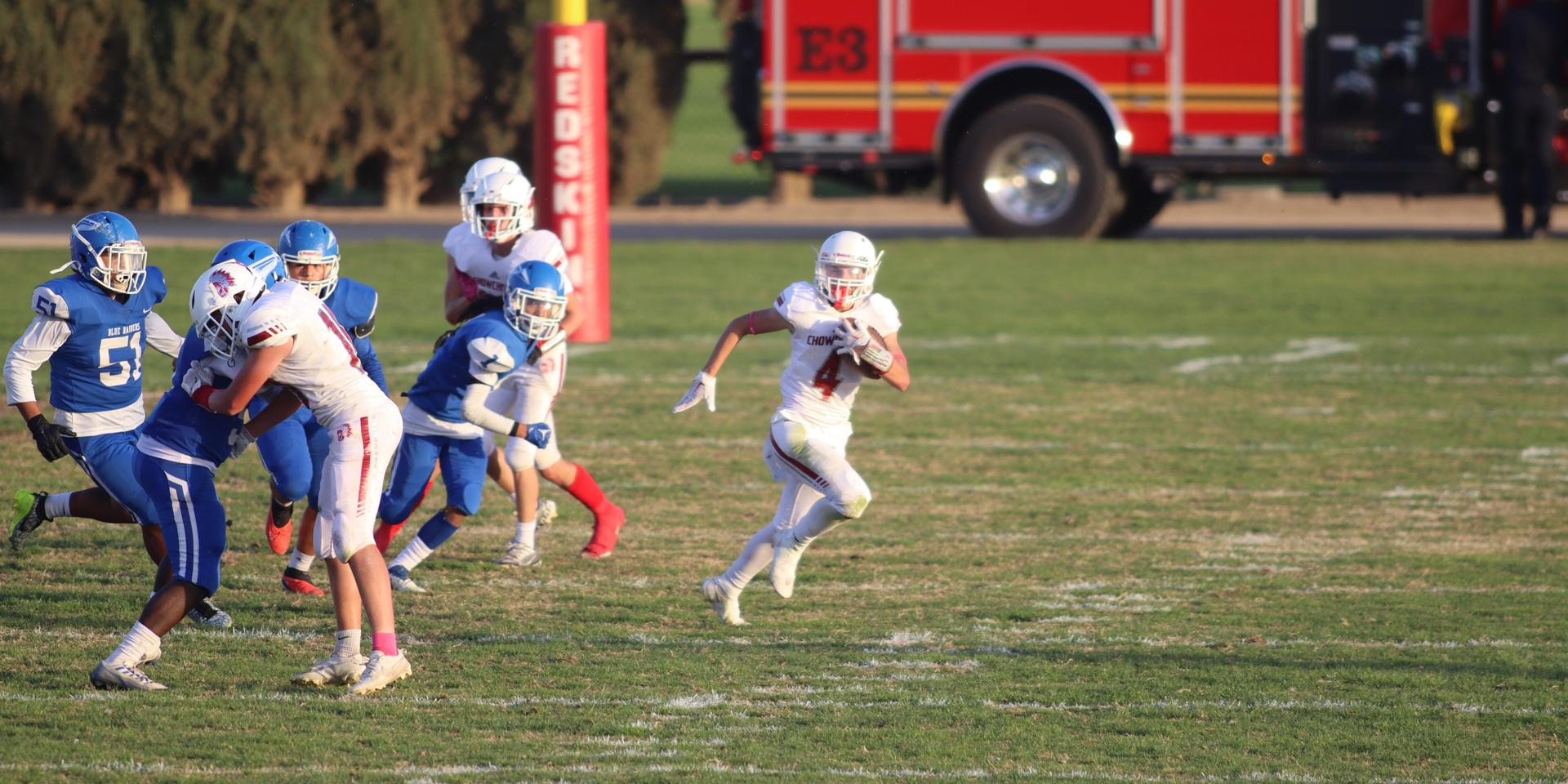 Junior Varsity football players in action against Caruthers