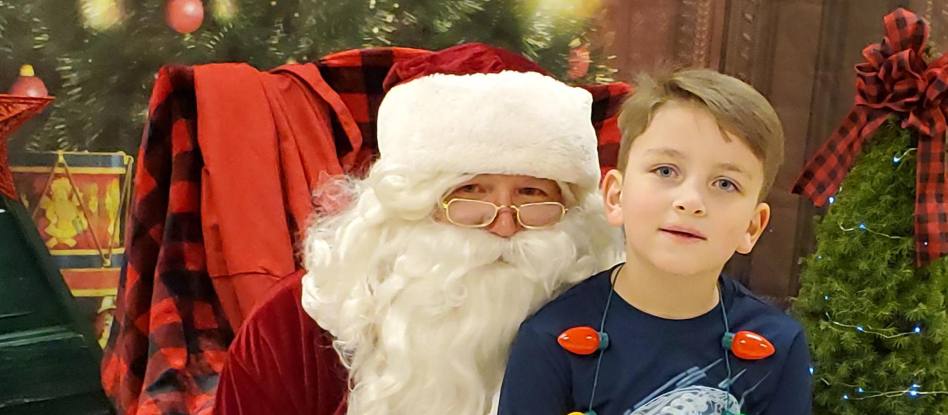 student sitting on Santa's lap