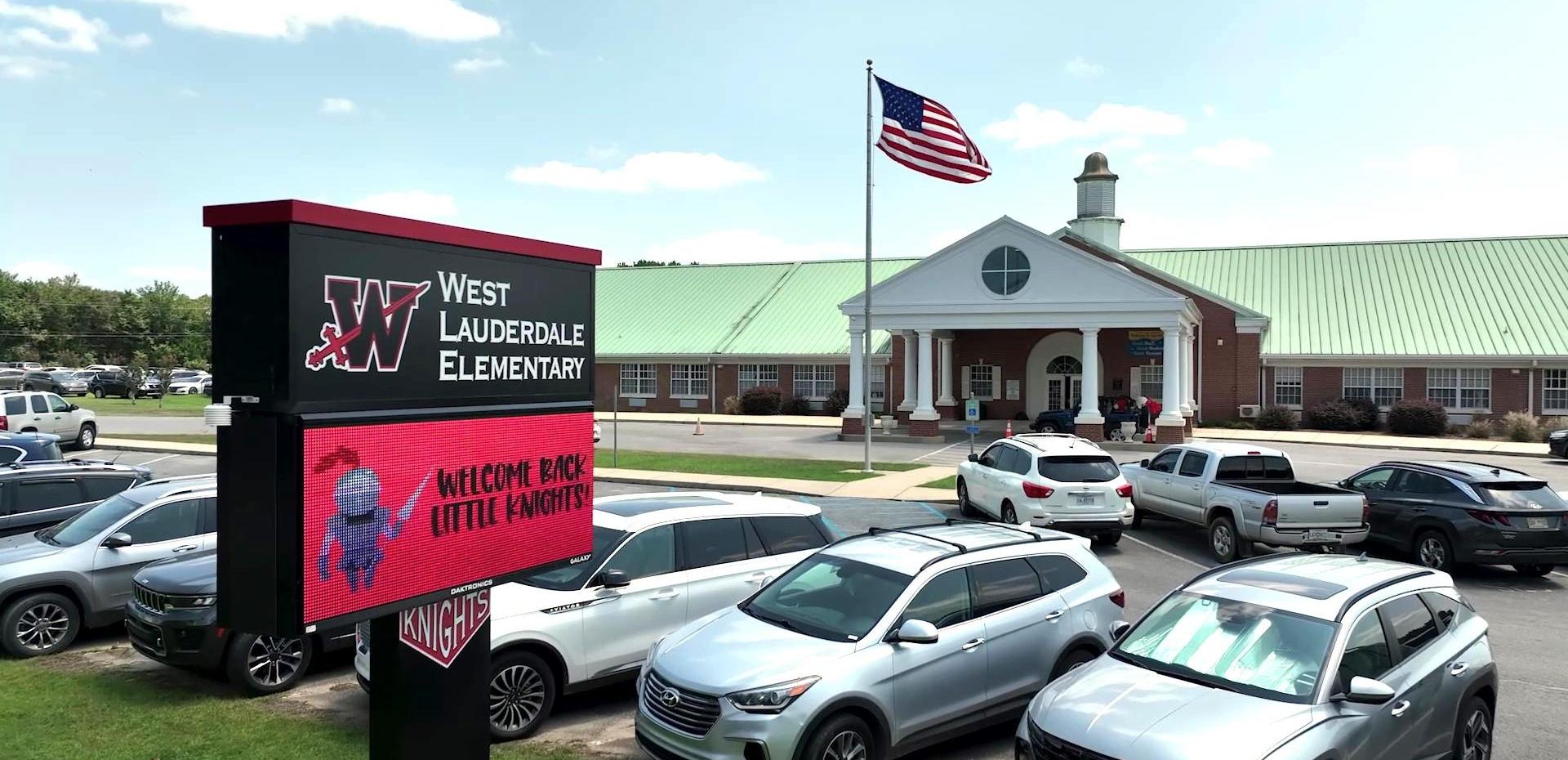 West Lauderdale Elementary School with a large digital sign and flag.