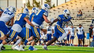 chase campbell action shot from football game running with ball