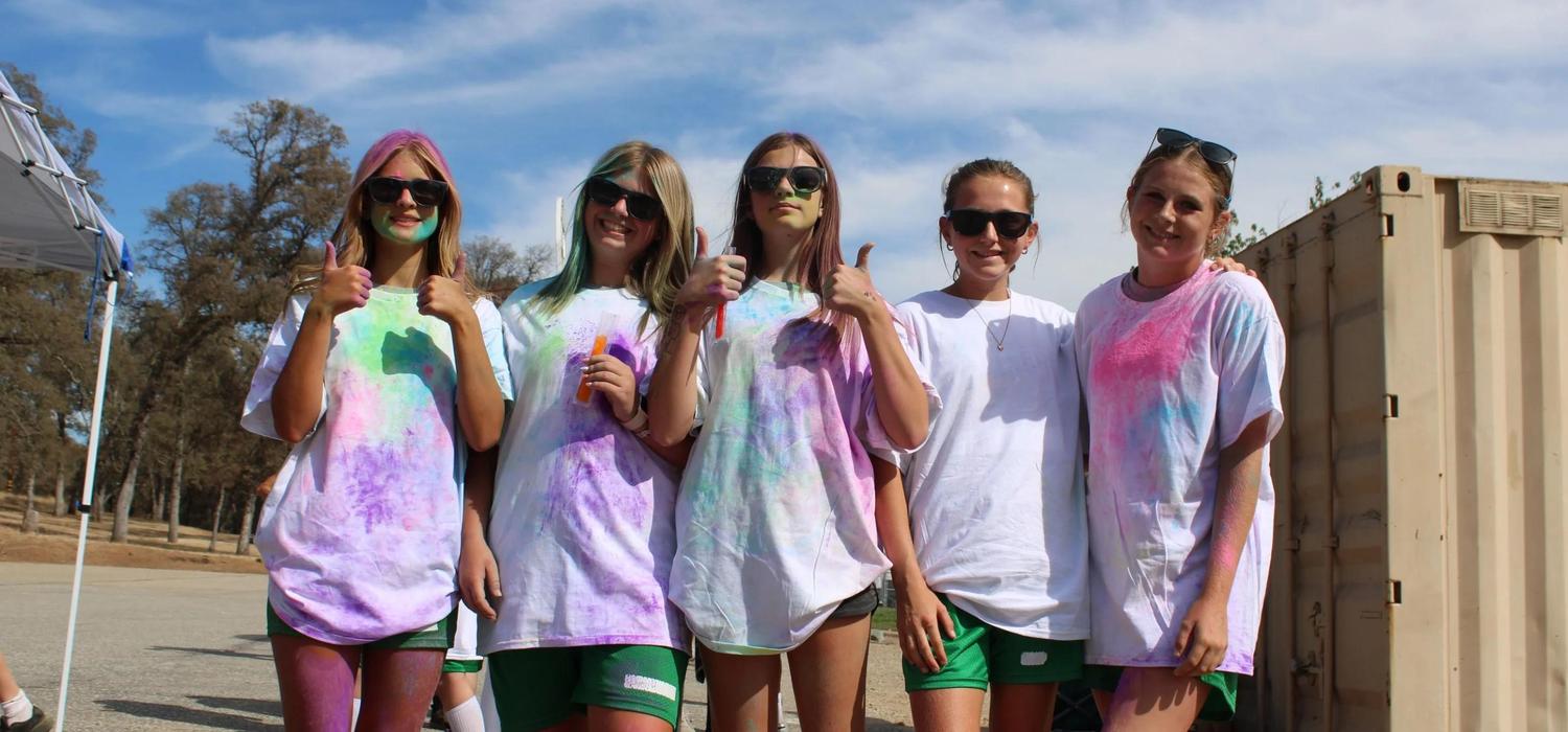 Students posing with thumbs up after the Color Run