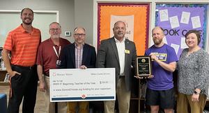School and Community Leader present Beginning Teacher of the Year award to Brandon Weaver of Mulberry Elementary School.