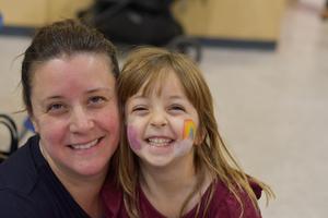 a mother and daughter posing at the fall festival