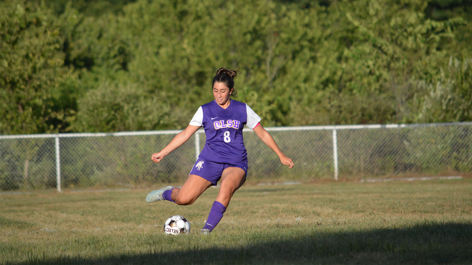 OLSH girls soccer player kicks the ball