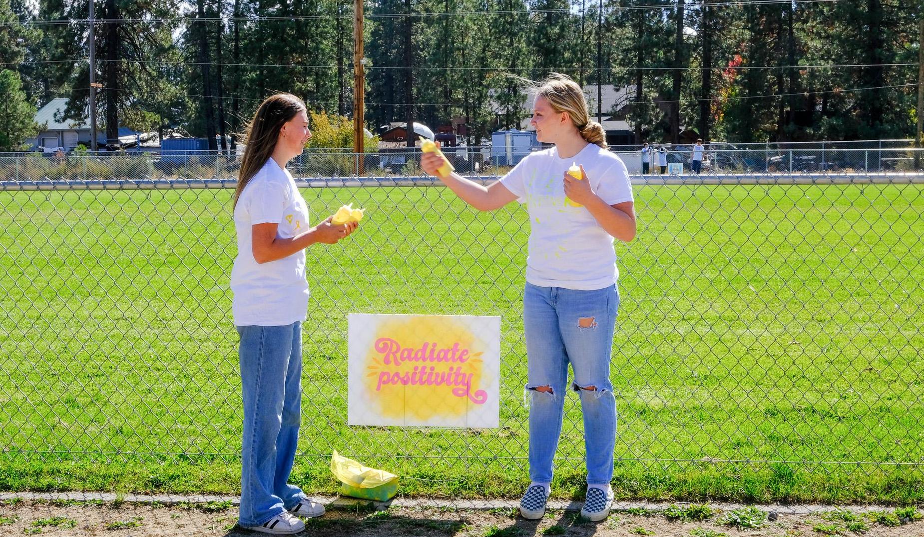 Two students get ready for a Color Run event.