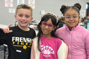Three students smiling at Elementary UIL Competition.