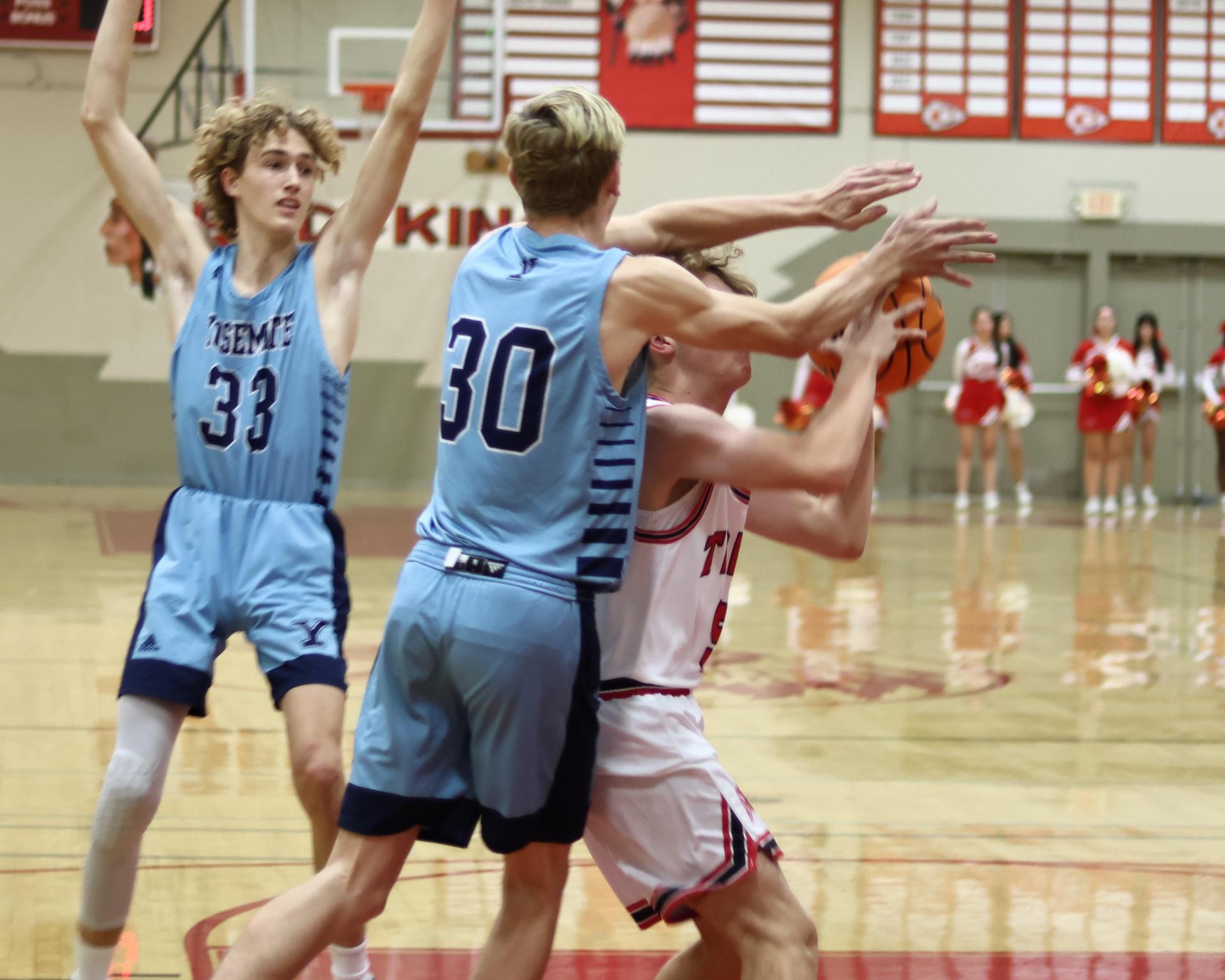 Varsity boys playing basketball against yosemite