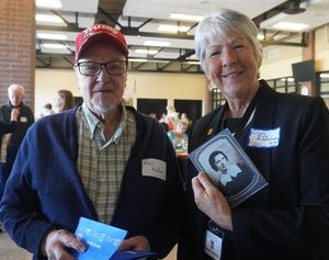 Neil Keller gives a photo of his mother, Neola (class of 1936) to the TKAA historian..