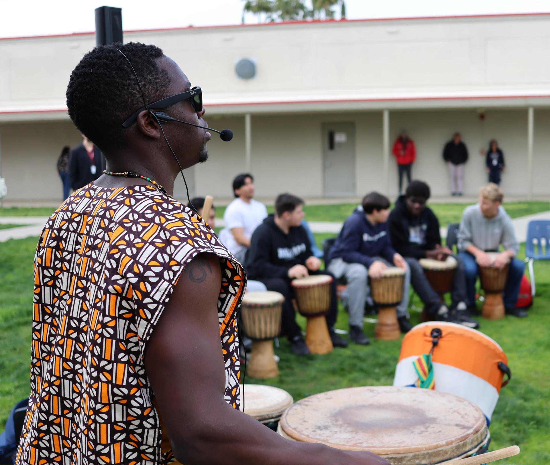 students and staff participating with the African Drum Interactive