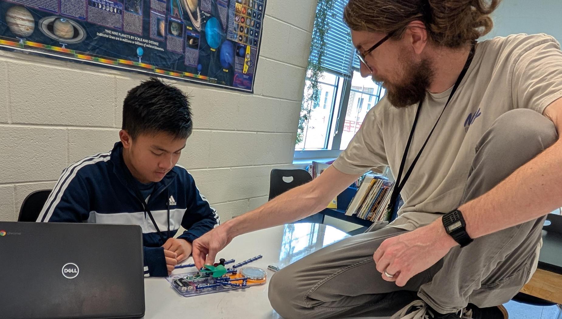 Mr. Ulrich helping a student make a circuit