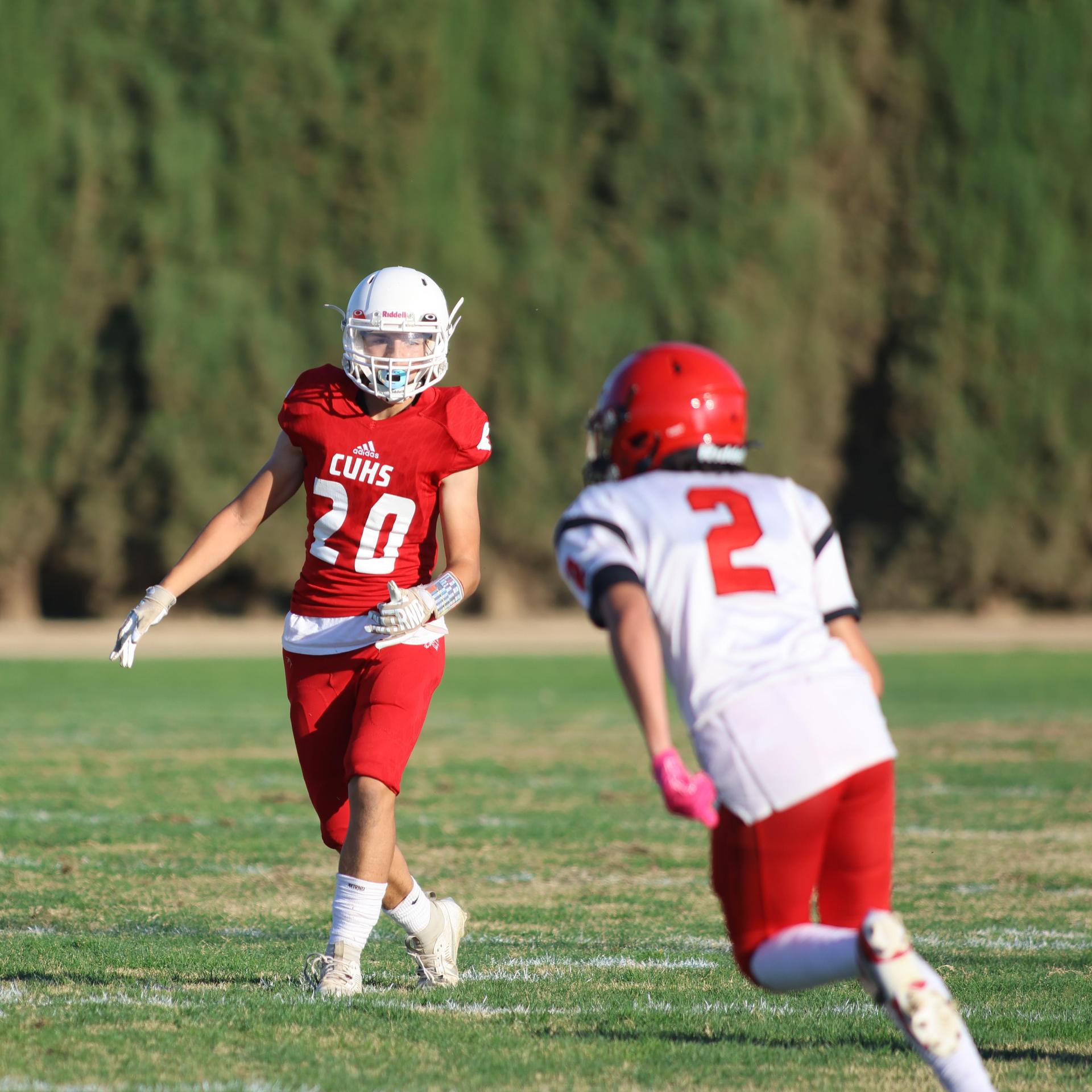 junior varsity football players in action against Fowler