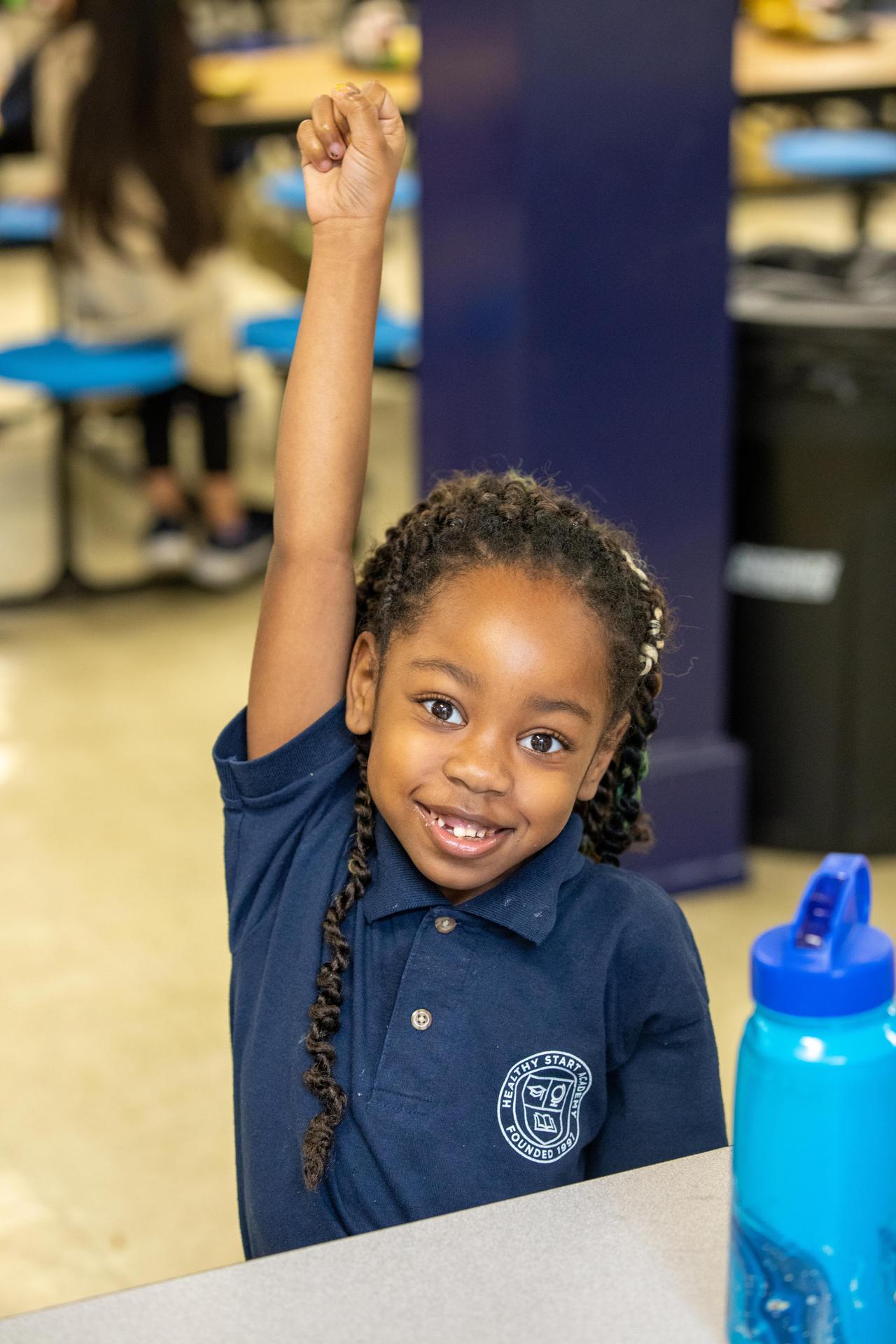 child raising hand