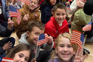 Level Green students waved American flags at their schoolwide assembly
