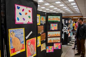 Attendees at the 2025 Spring Fling explore the expansive student art gallery.