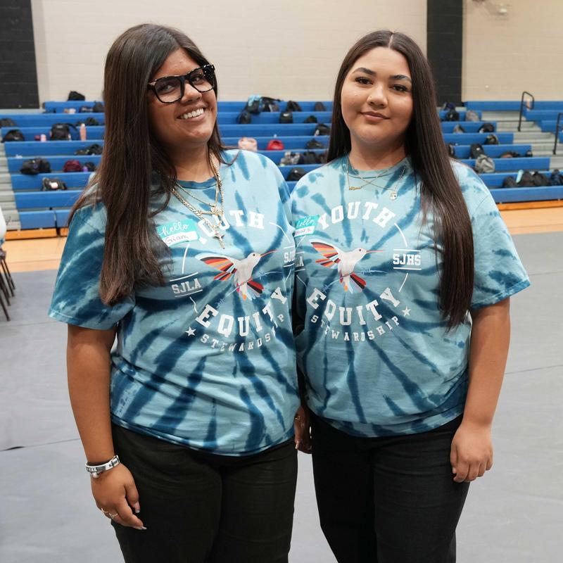 two students in matching YES symposium t-shirts