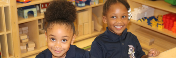 two pre-k knight girls smiling