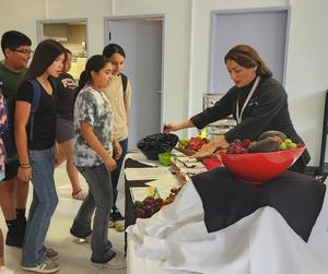 Chef encouraging students to try the new Caribbean flavor