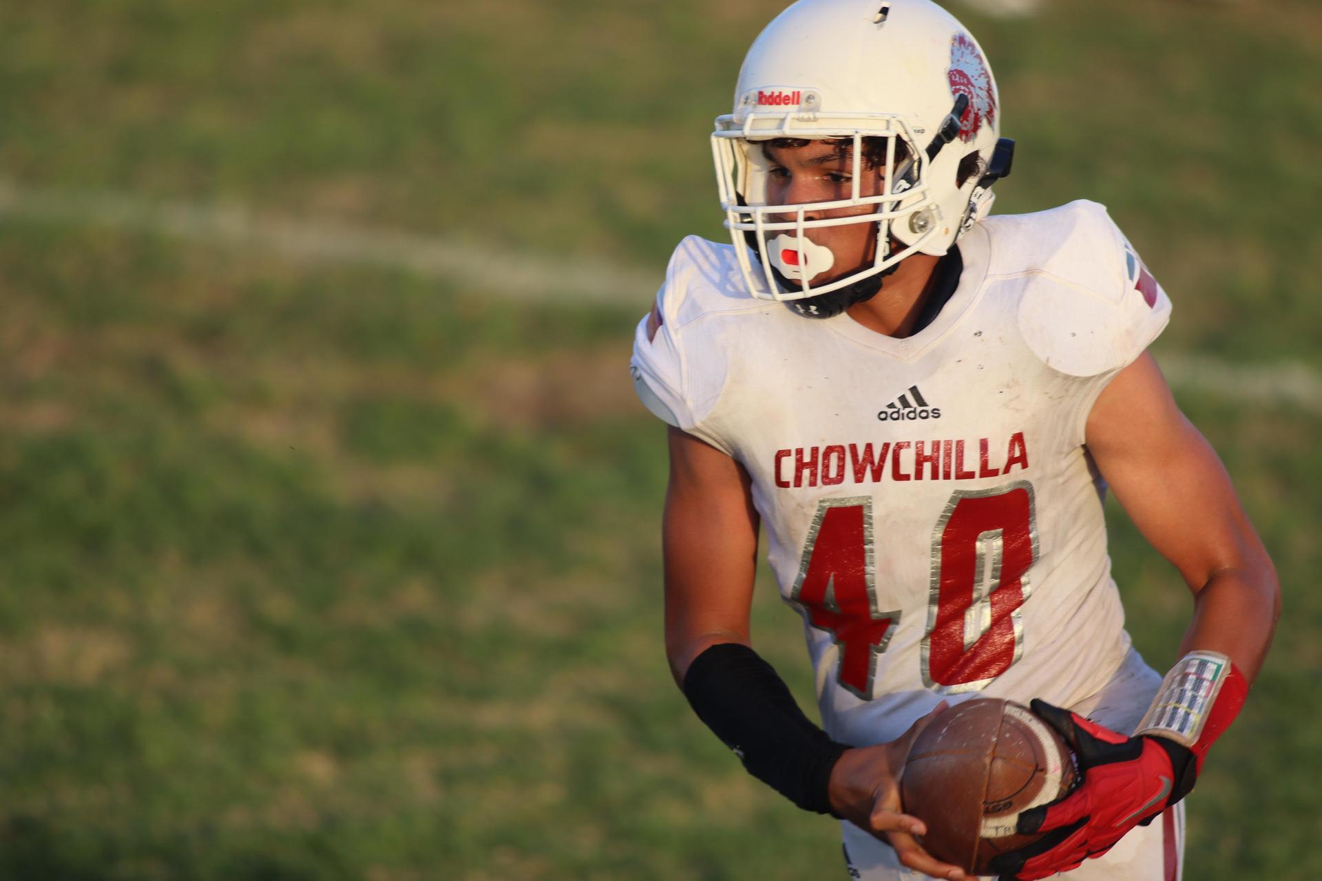 Junior Varsity football players in action against Caruthers