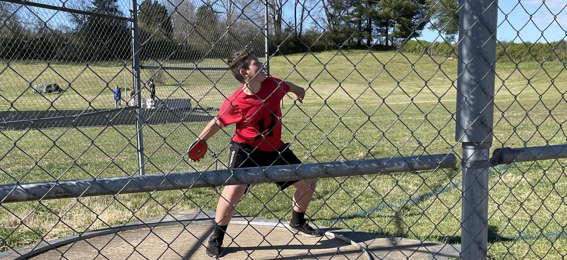 A student throws a discus.