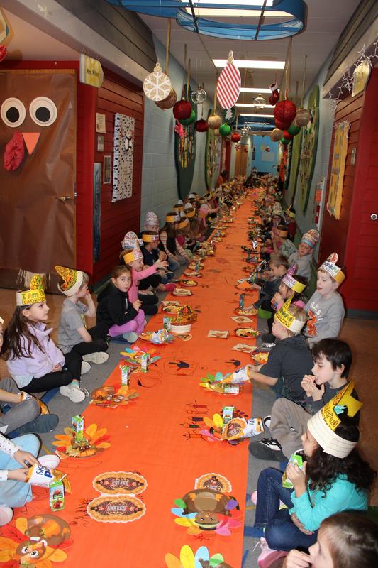 hallway full of kindergarten students eating thanksgiving snack