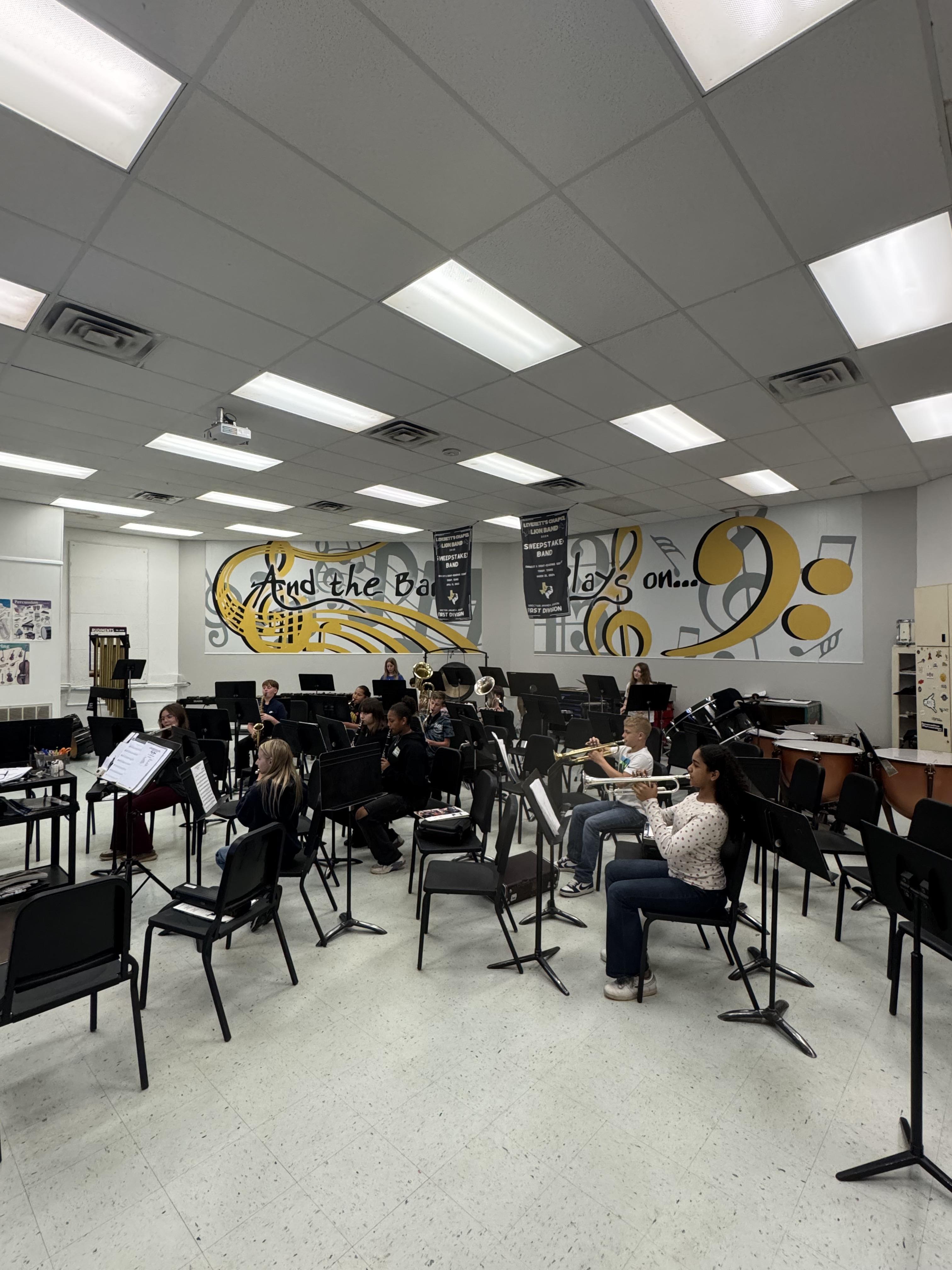 Sixth grade band performing for PreK.