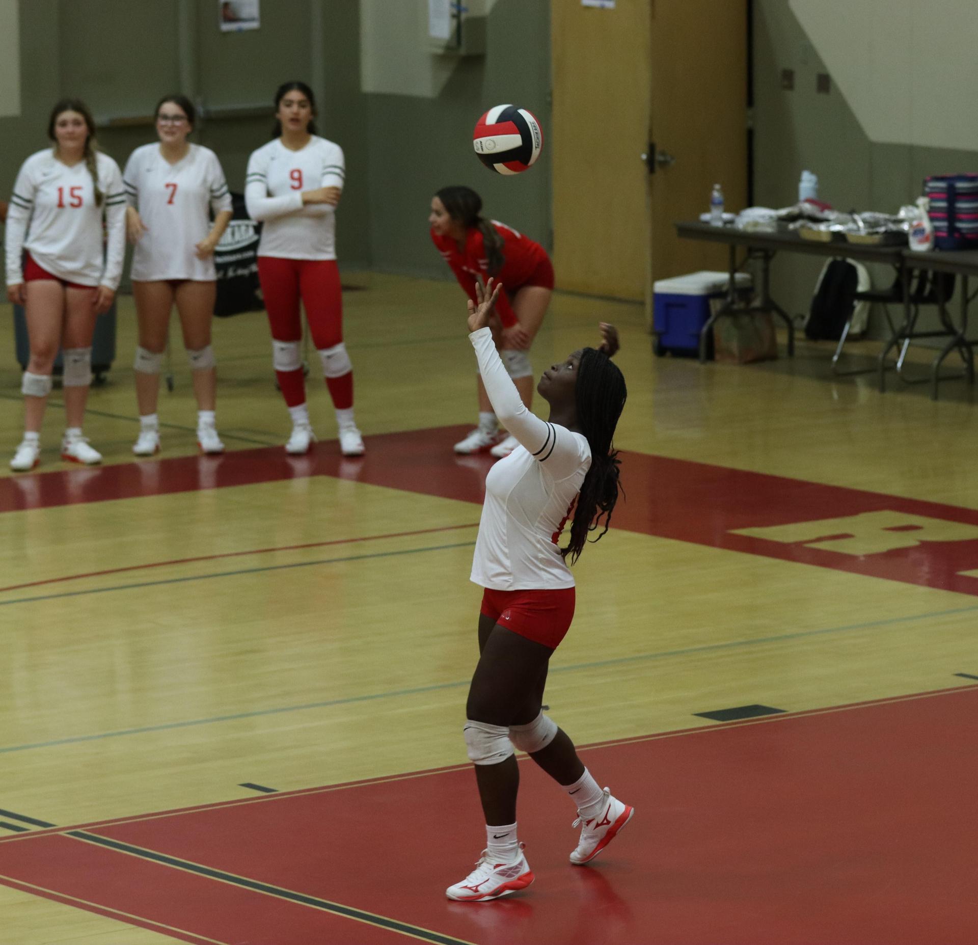 varsity volleyball players in action against liberty
