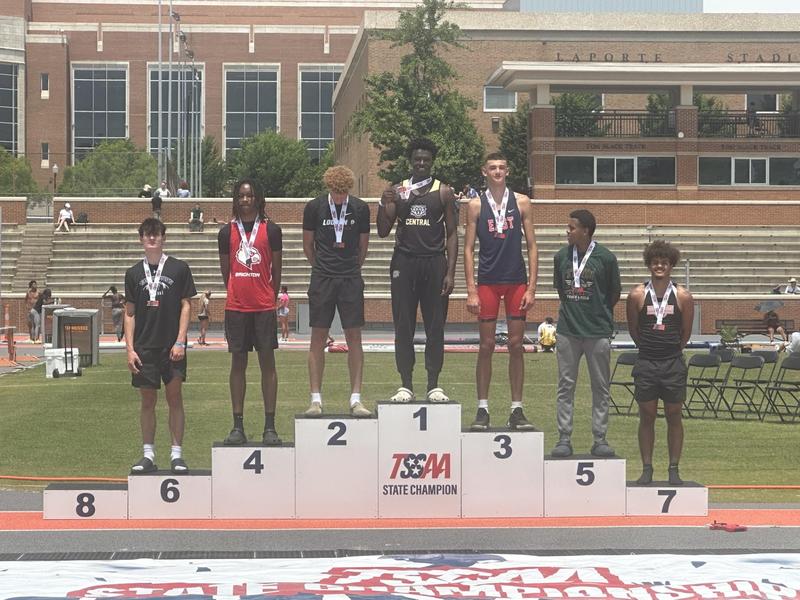 Chukwudi Obi wins state title in high jump. Pictured with young men who won 2nd thorugh 8th place.