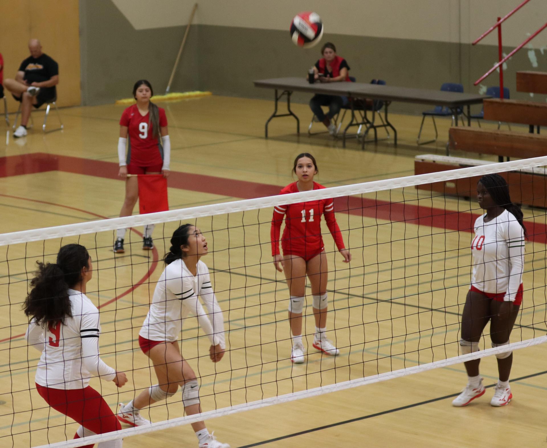 varsity volleyball players in action against Fresno Christian