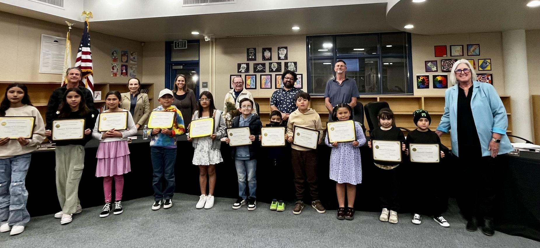 JDUSD Students proudly holding certificates at a recognition event.