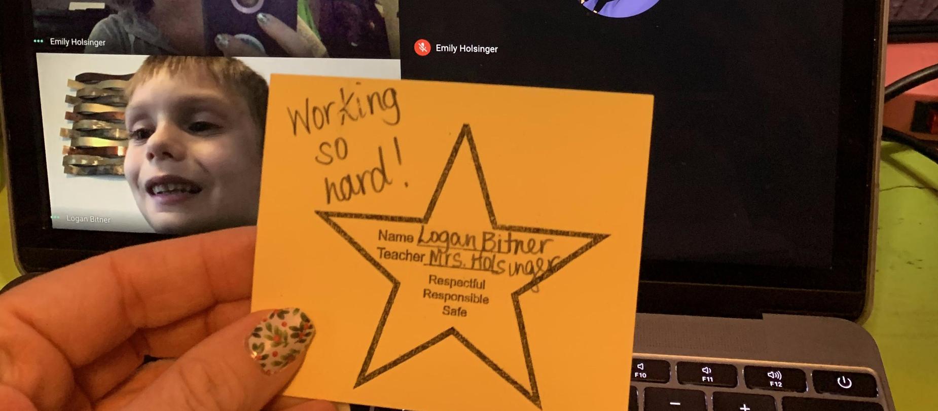 boy on computer screen receiving a virtual star for working hard
