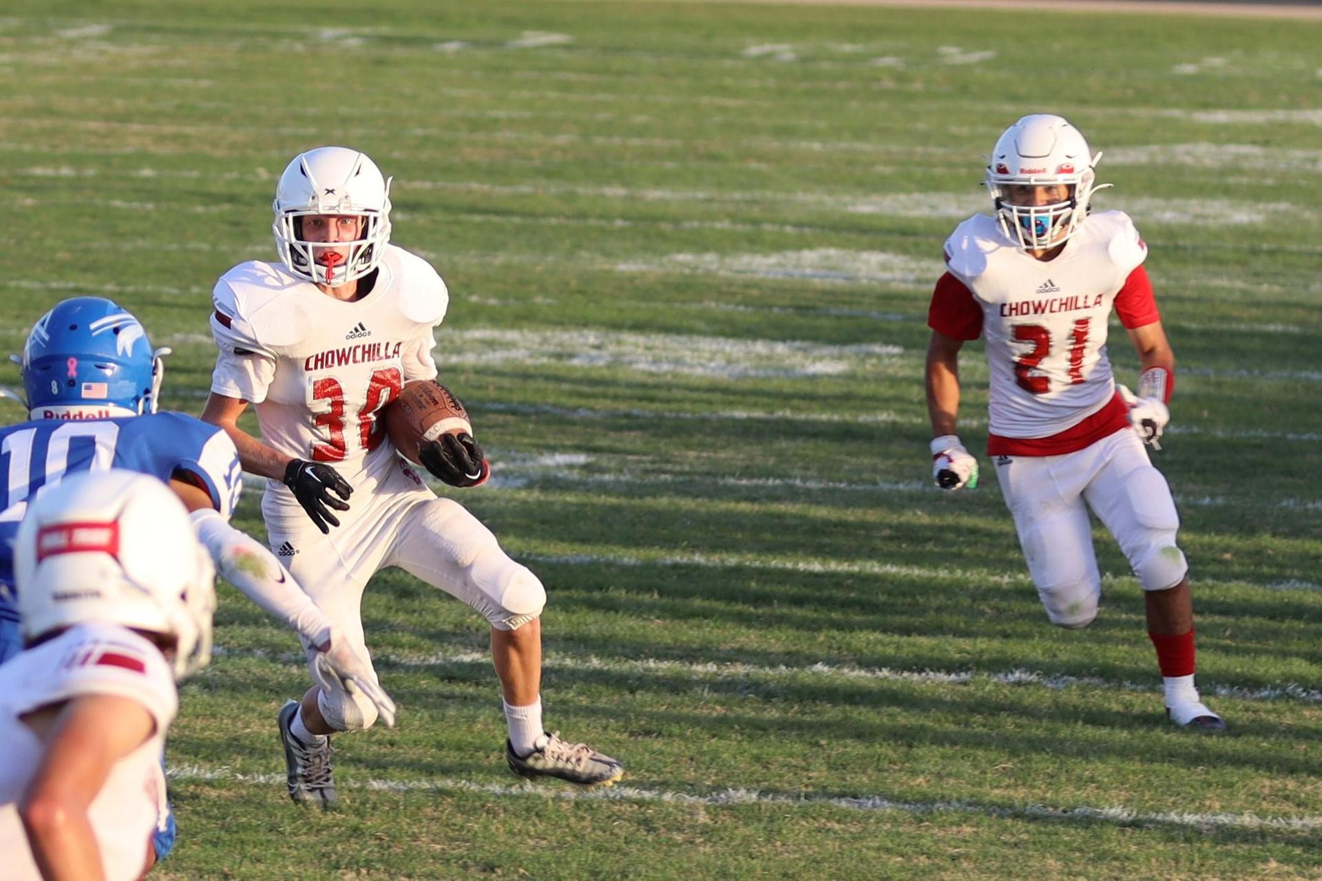 Junior Varsity football players in action against Caruthers