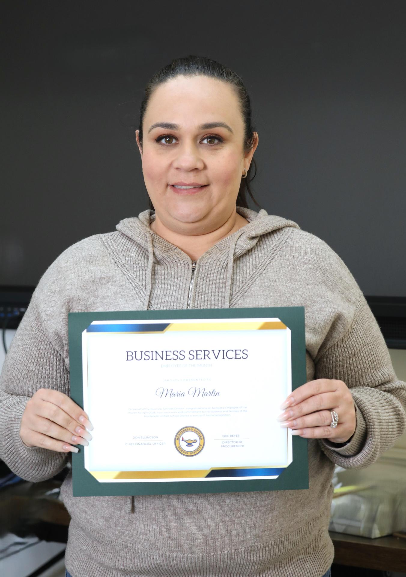 Picture of employee holding certificate 