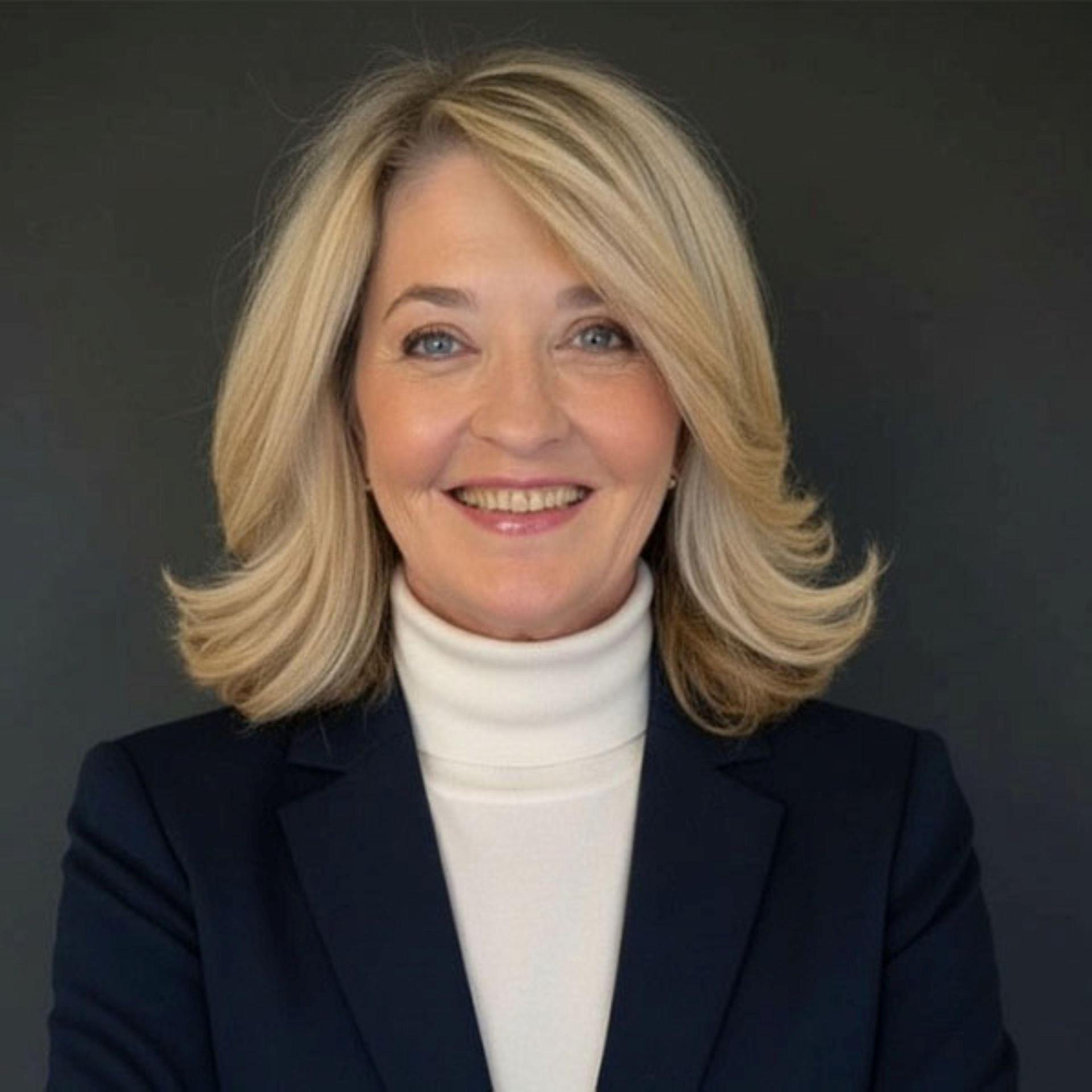 Karen Reinsel in a white tutleneck and black jacket.