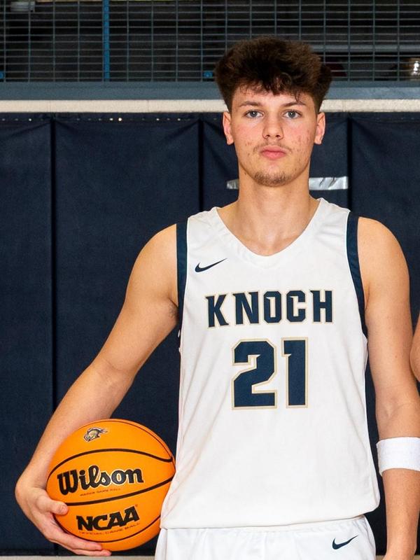boy wearing jersey 21 holding a basketball