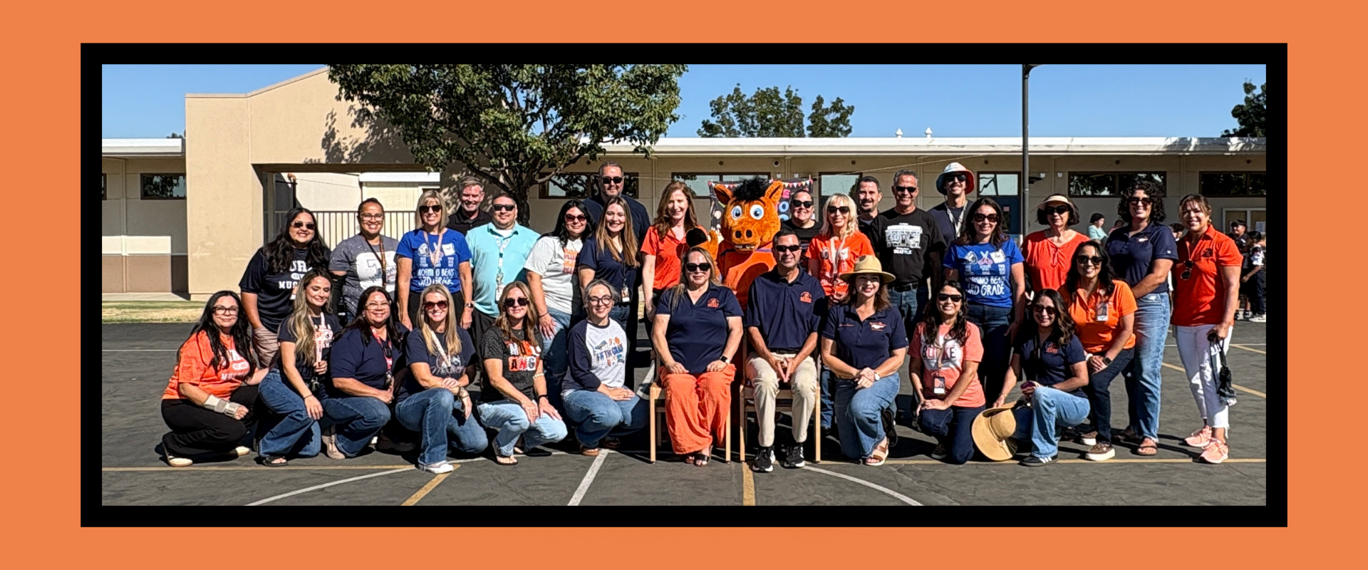 Burke Elementary staff posing together outdoors in a school setting.