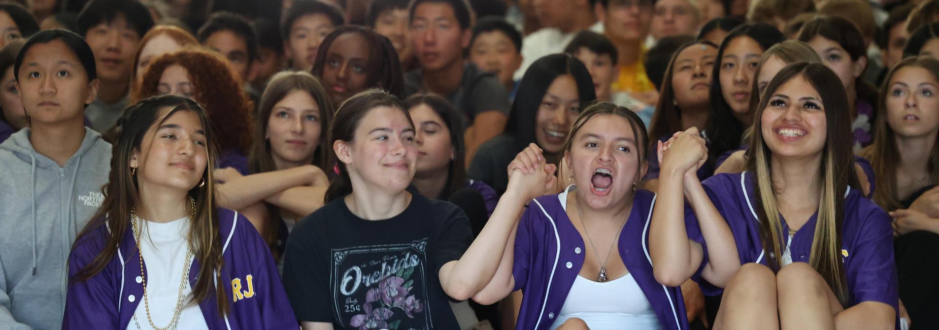 students looking up and cheering