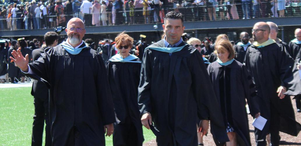 principal kelley and superintendent haynes lead commencement entrance