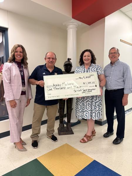 Mrs. Madonna being awarded a large check.
