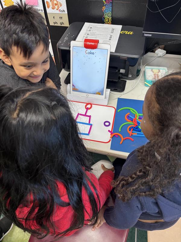 Students following instructions to create a cake!
