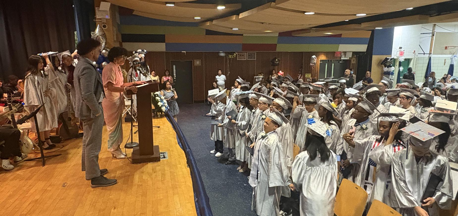 Auditorium with students in graduation caps and gowns