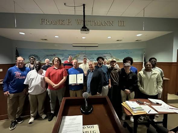 Tonight, the Pirates were shining at the City of Pass Christian Board of Aldermen’s meeting.  The Pledge of Allegiance was led by Eloise Newman, and the City signed a proclamation to commemorate our historic football season.