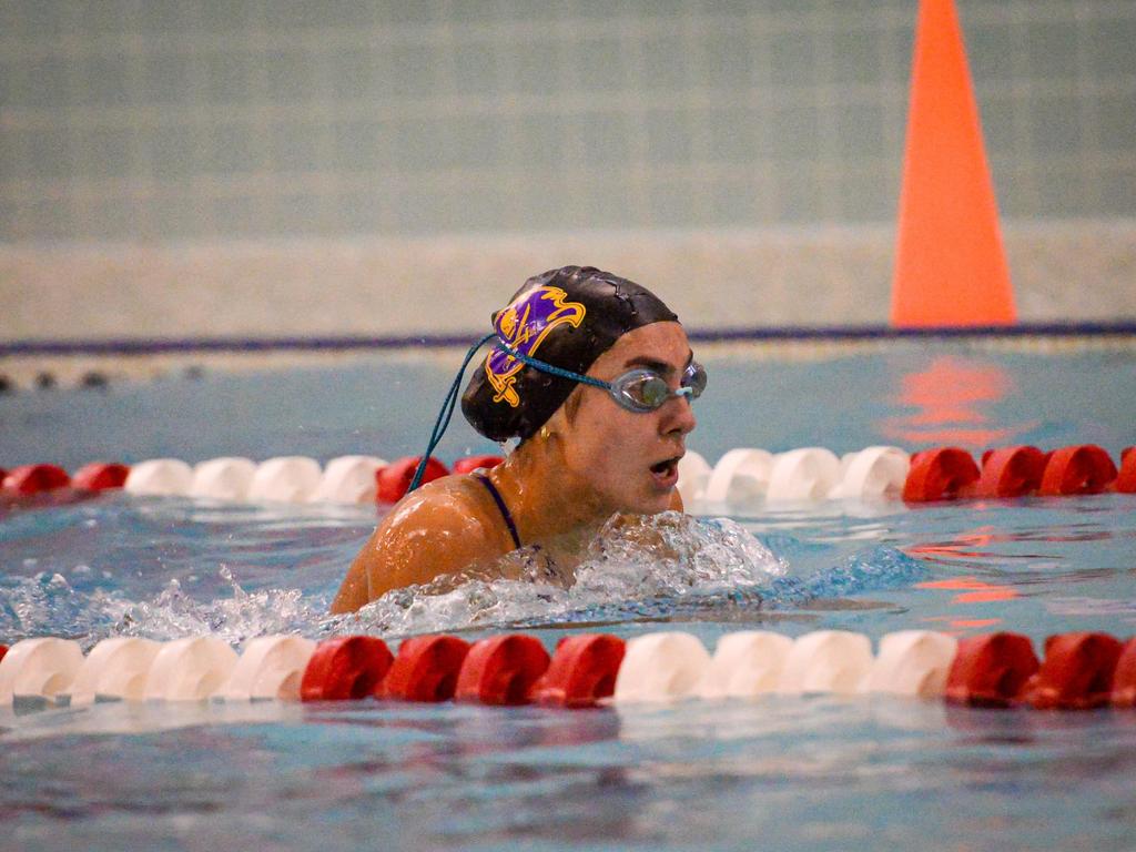 A swimmer doing breaststroke in a pool lane.
