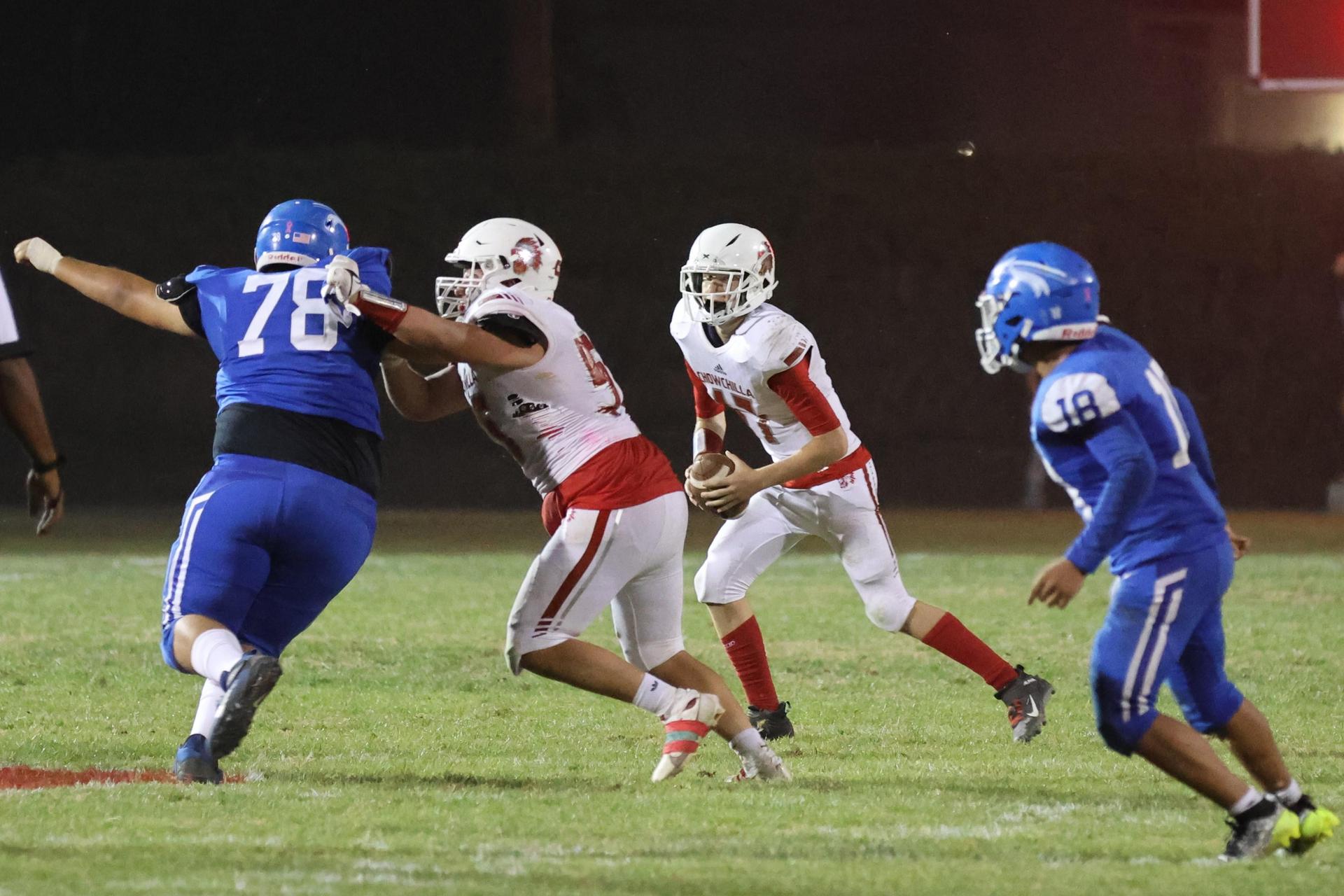 Junior Varsity football players in action against Caruthers