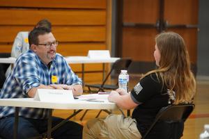 A local company representative interviews a senior TKHS student.