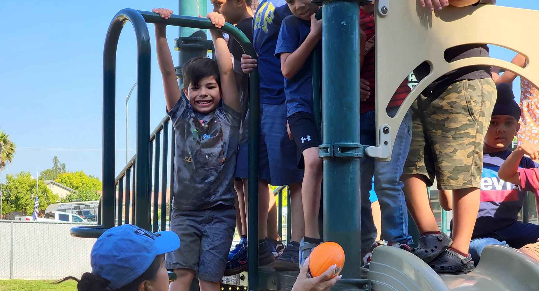 Student enjoys the playground with friends