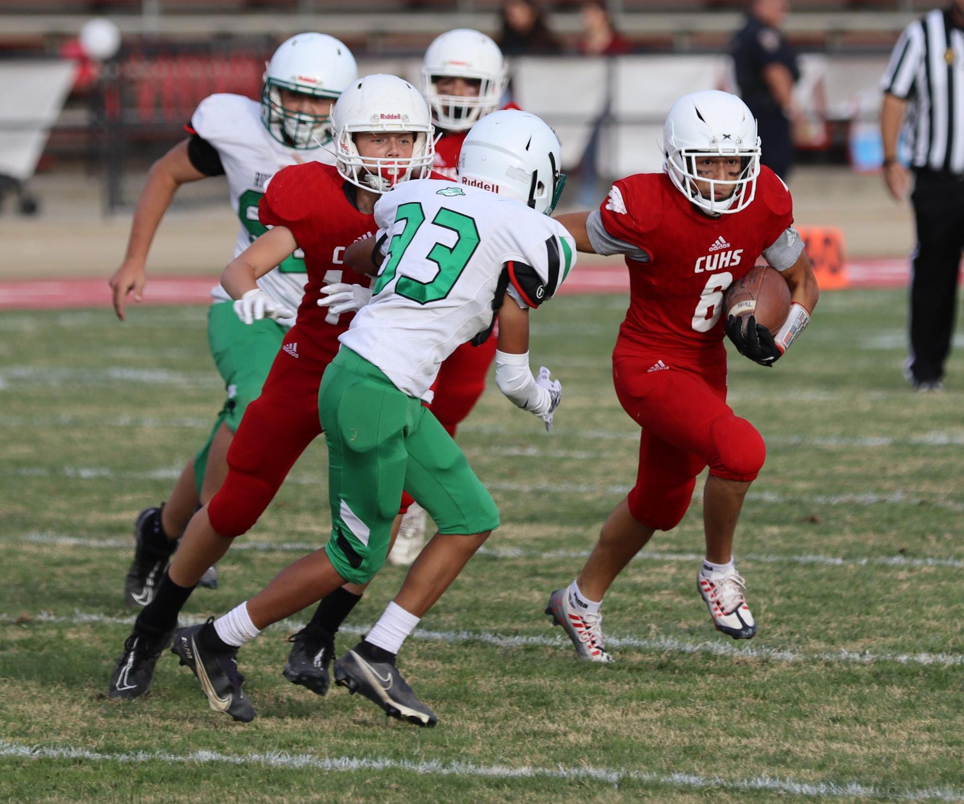  junior varsity football players in action against riverdale