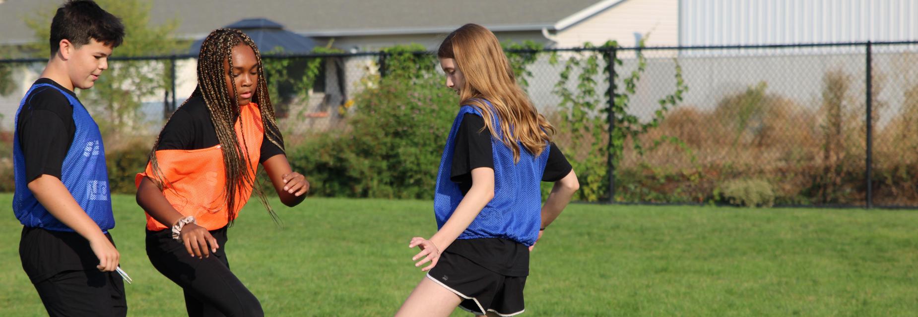 soccer players kicking ball