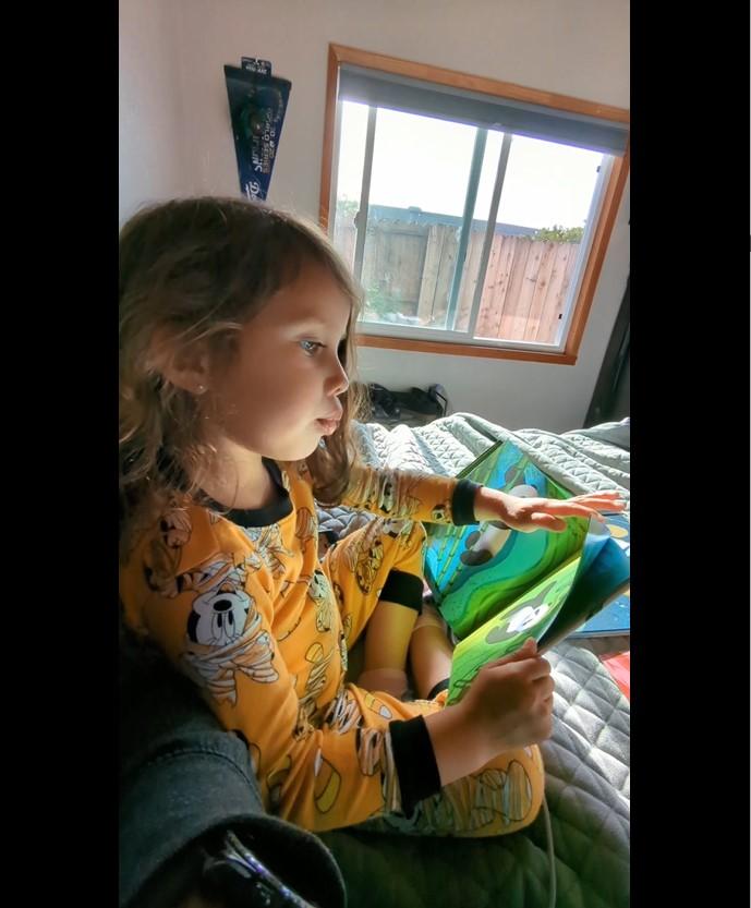 Raise A Reader image of child reading a book