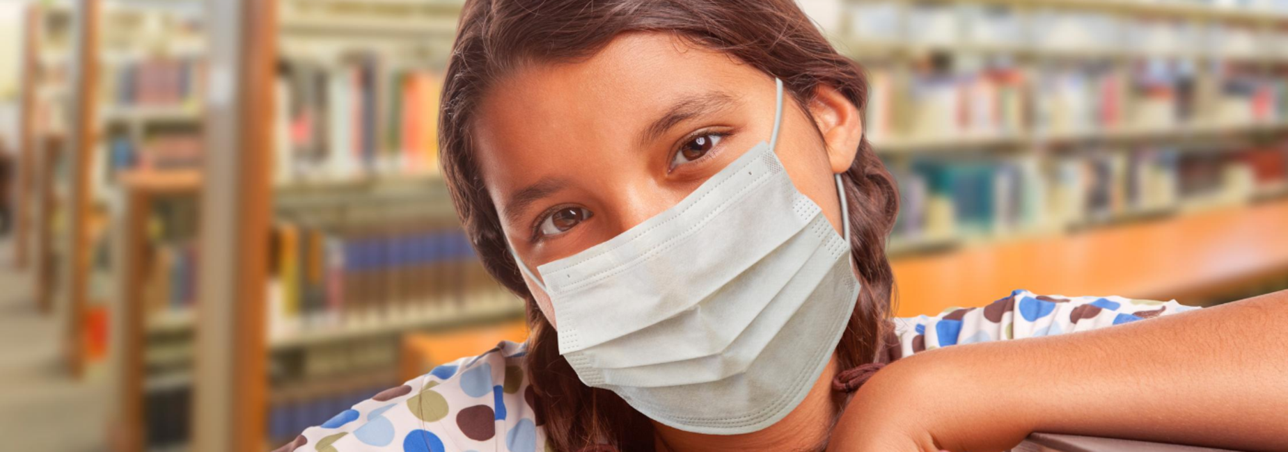 girl wearing face mask in library